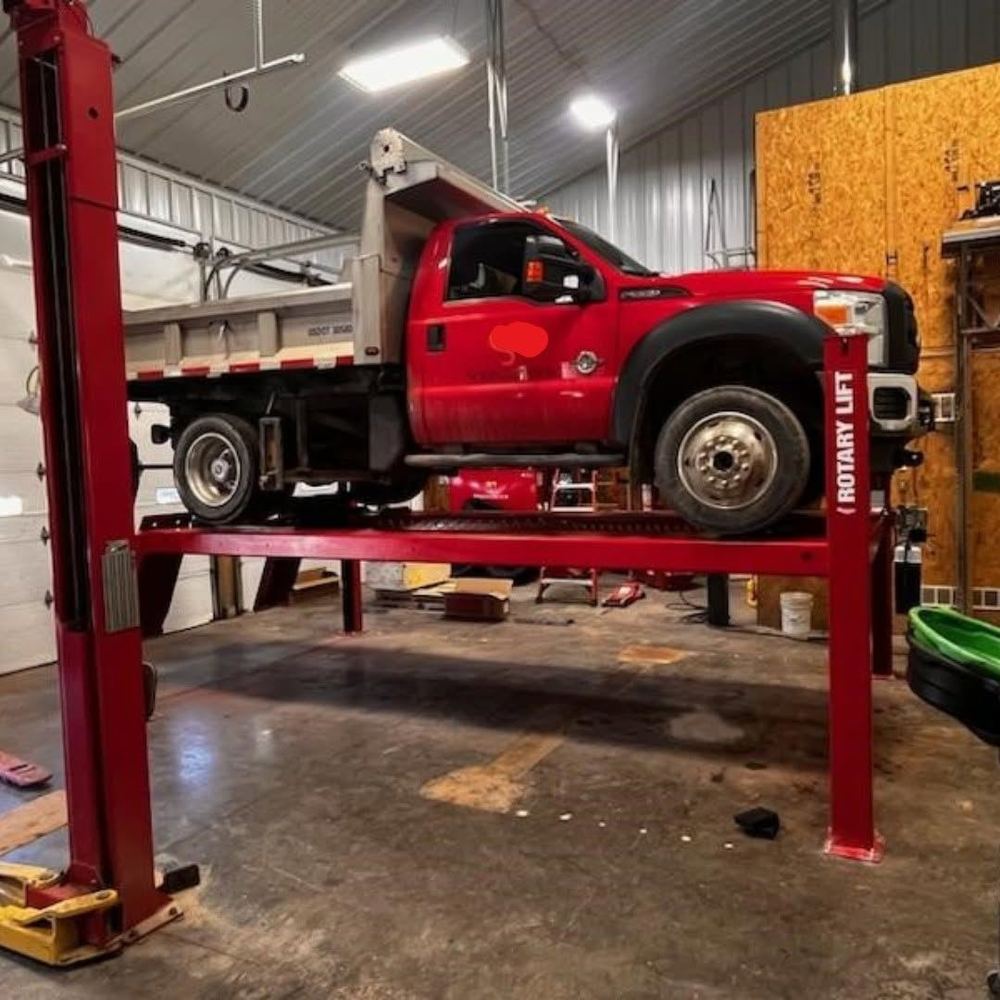 Heavy duty vehicle raised on a four post lift